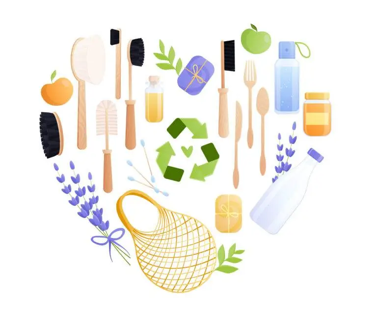 Heart-shaped flat lay of recyclable eco-friendly items on a white background