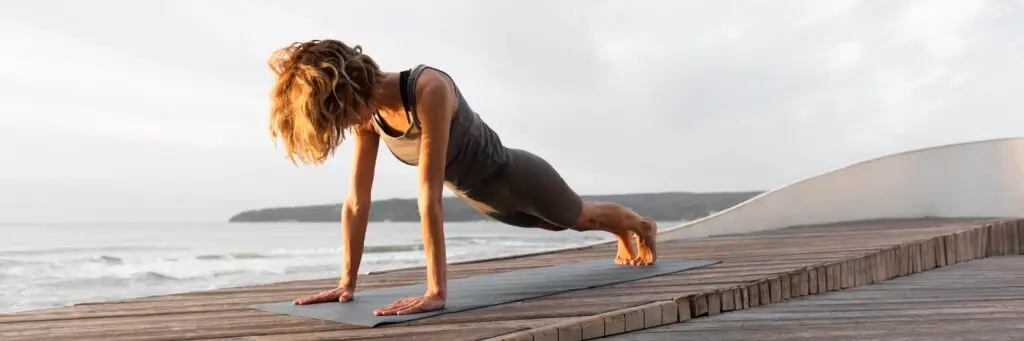 Woman doing plank outdoors as part of her exercise for clear skin routine