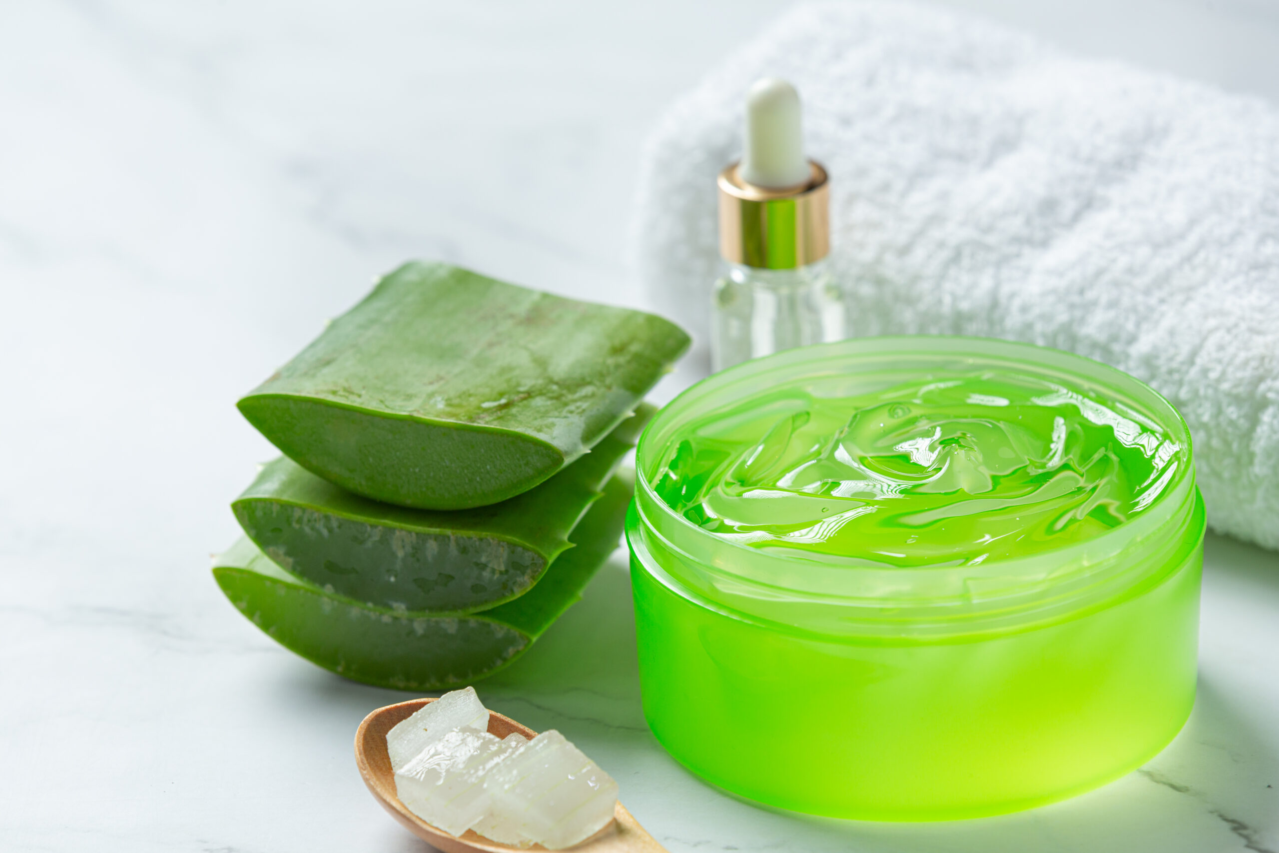 Aloe Vera for sunburn relief cosmetic cream on a white surface, ideal for soothing and healing sunburned skin