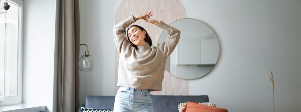 Dancing with hands raised, expressing joy and the lightness of minimalism