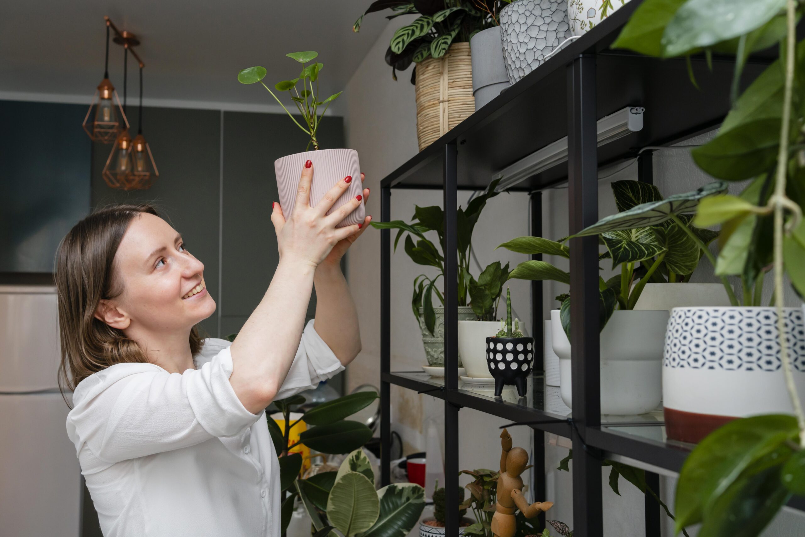 Woman practicing sustainable gardening by tending to her plants at home